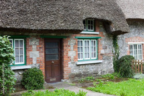 Adare (Ireland), - July 20, 2016: House with a thatched roof, Adare, County Limerick, Ireland photo