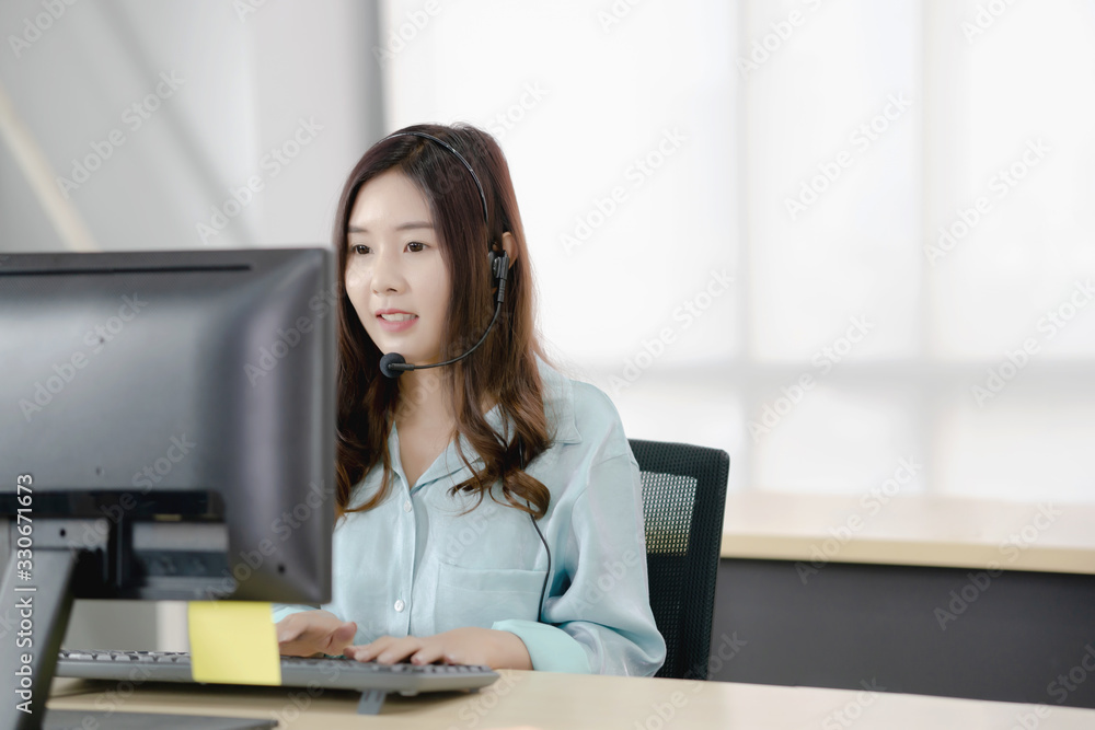 Young female operator with headphone Young female operator with headphone