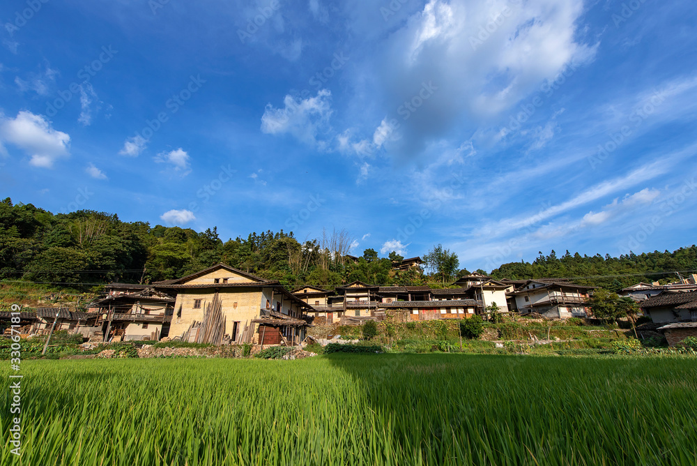 Country houses under blue sky and white clouds Country houses under blue sky and white clouds