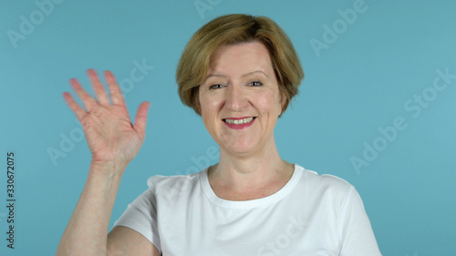 Wallpaper Mural The Old Woman Waving Hand to Welcome Isolated on Blue Background Torontodigital.ca