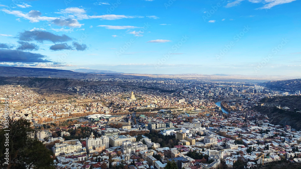 TBILISI, GEORGIA  DECEMBER 14, 2019:  Beautiful aerial view of the central part of city    and blue sky in Tbilisi, Georgia