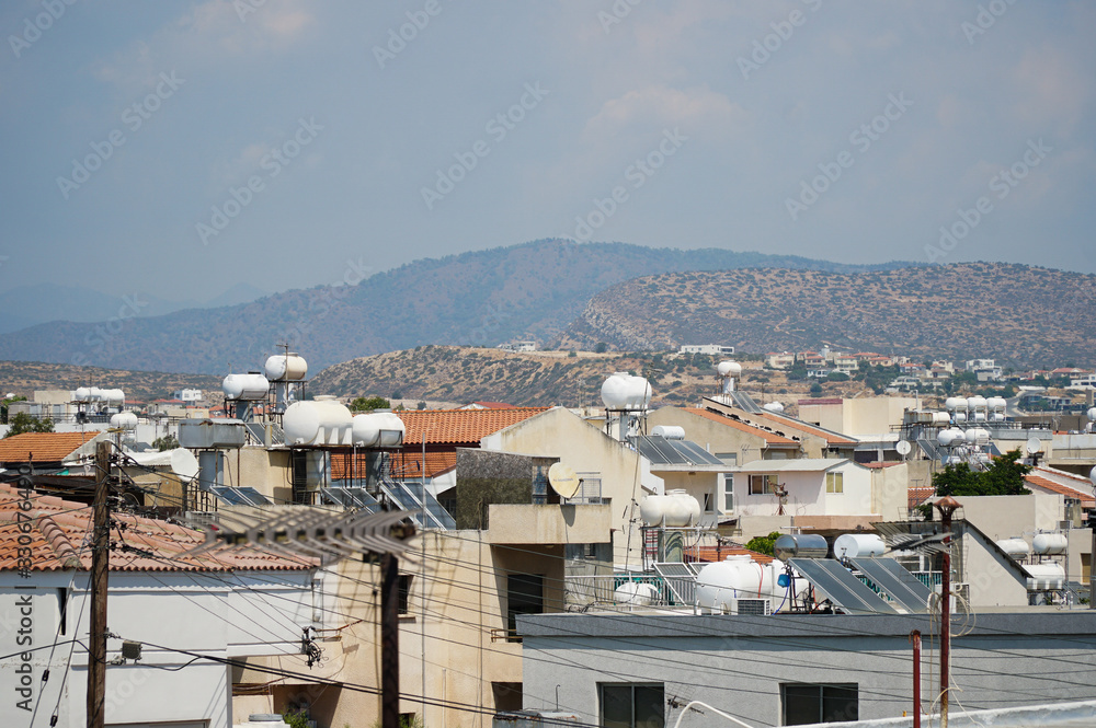 Roofs of houses with solar panels on the back of the mountains, Limassol, Cyprus