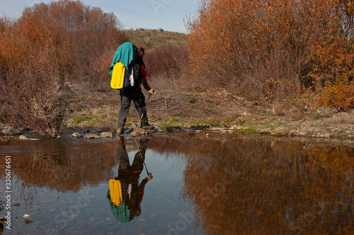 Peregrino de la Vía de la Plata cruzando un arroyo entre las localidades extremeñas de Grimado y Galisteo. photo