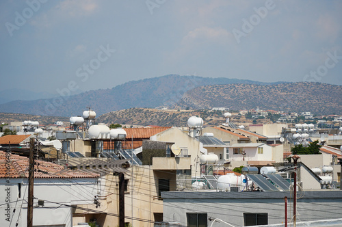 Roofs of houses with solar panels on the back of the mountains, Limassol, Cyprus © Елизавета Шагал
