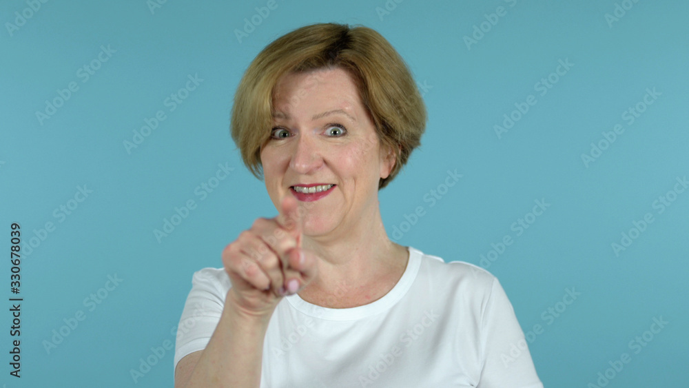 The Old Woman Inviting Customers with Both Hands Isolated on Blue Background The Old Woman Inviting Customers with Both Hands Isolated on Blue Background