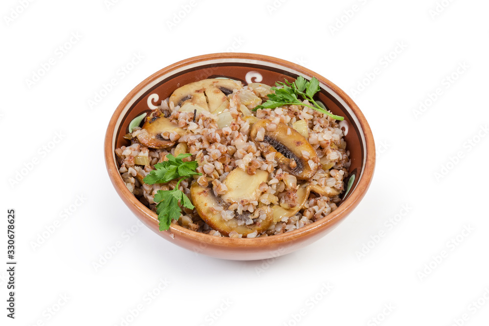 Buckwheat porridge with fried mushrooms and onions in clay dish Buckwheat porridge with fried mushrooms and onions in clay dish