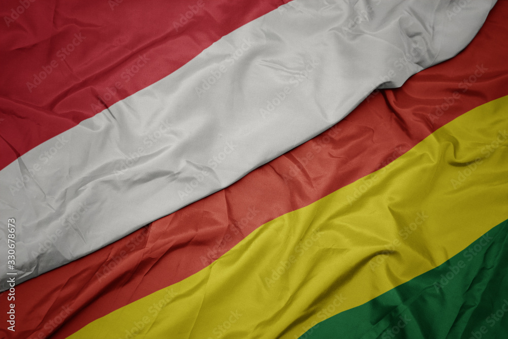 waving colorful flag of bolivia and national flag of indonesia. waving colorful flag of bolivia and national flag of indonesia.