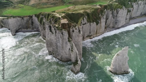 Aerial bird view of Étretat chalk cliffs Normandy showing three natural arches and a pointed formation called L'Aiguille or Needle the walls consists of complex stratigraphy of Turonian and Coniacian photo