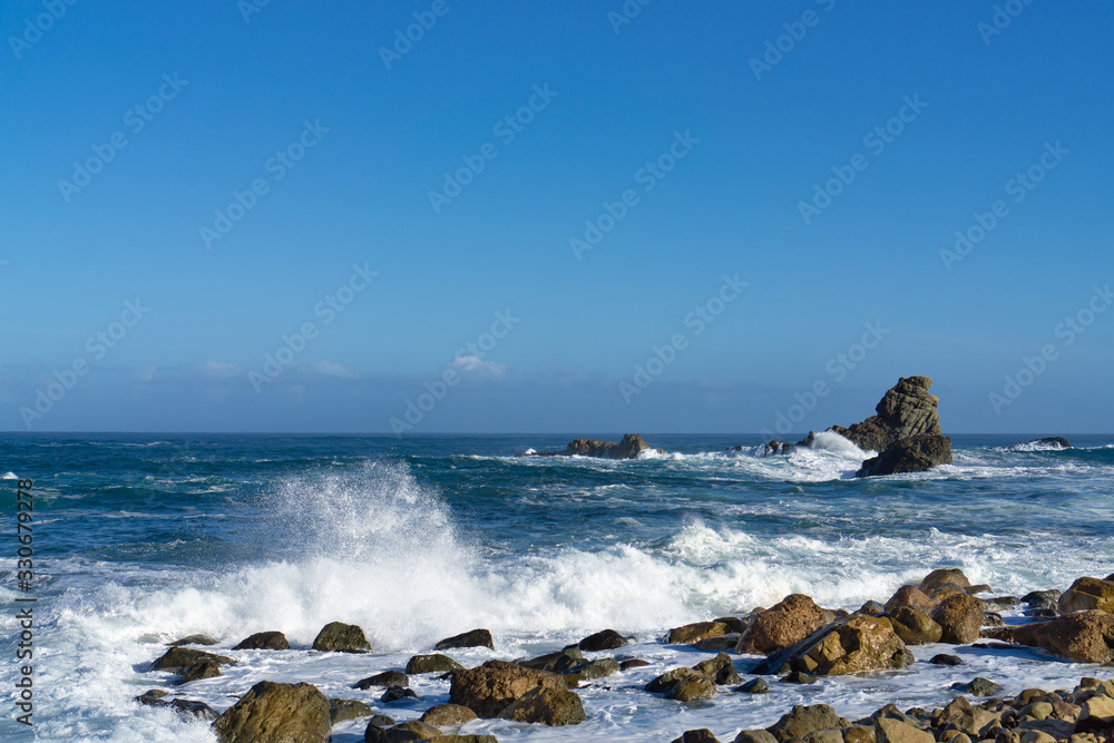 The rough Atlantic Ocean near Tenerife, Spain, strong waves break on the rocks in the water