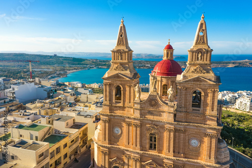 Aerial view close up view of Mellieha Parish Church or Birth of Our Lady. Sea and blue sky. Malta island