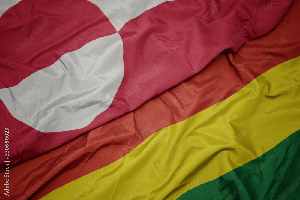 waving colorful flag of bolivia and national flag of greenland. waving colorful flag of bolivia and national flag of greenland.