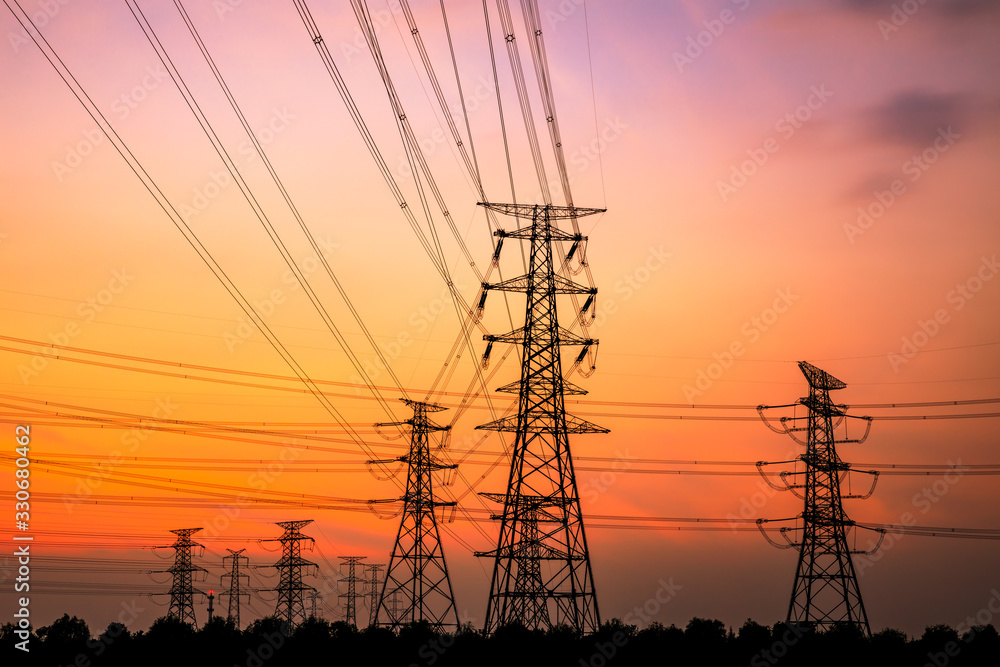 Industrial high voltage electricity tower and beautiful nature landscape at summer sunset