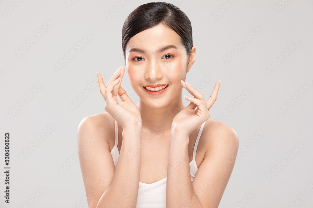 Beautiful Asian young woman touching soft cheek smile with clean fresh skin Happiness and cheerful with positive emotional,isolated on white background,Beauty Cosmetics and Facial treatment Concept Beautiful Asian young woman touching soft cheek smile with clean fresh skin Happiness and cheerful with positive emotional,isolated on white background,Beauty Cosmetics and Facial treatment Concept