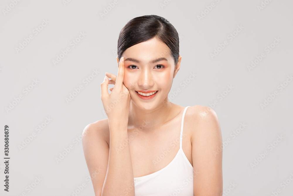 Beautiful Asian young woman touching soft cheek smile with clean fresh skin Happiness and cheerful with positive emotional,isolated on white background,Beauty Cosmetics and Facial treatment Concept