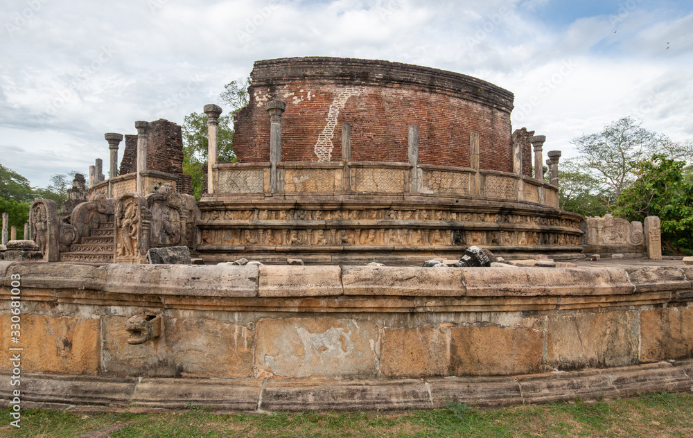 The ancient stone Buddha in Polonnaruwa Vatadage, Sri Lanka. Polonnaruwa Vatadage is a circular relic house, Built for the protection of a small stupa dating back to the Kingdom of Polonnaruwa.
