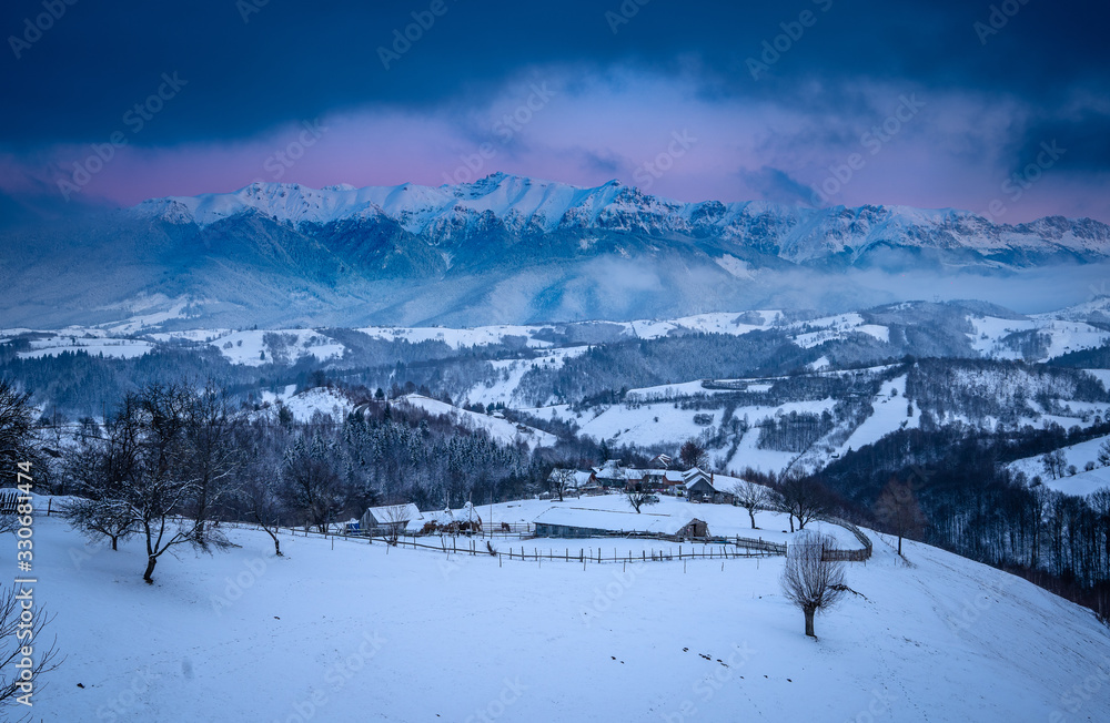 Pestera Village and the Carpathian Mountains at sunset in winter time Pestera Village and the Carpathian Mountains at sunset in winter time