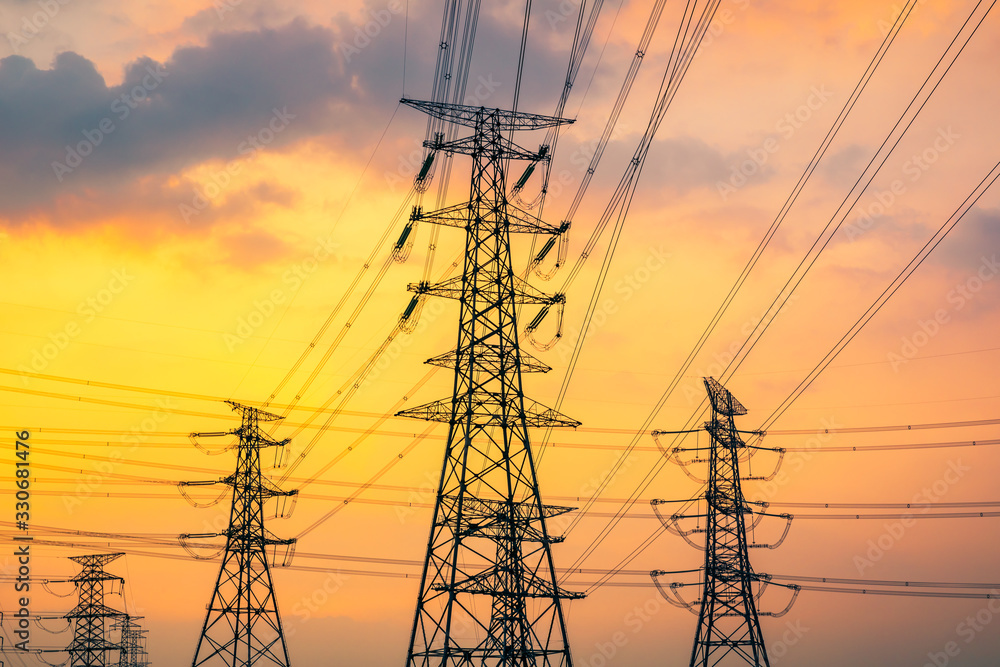 Industrial high voltage electricity tower and beautiful nature landscape at summer sunset