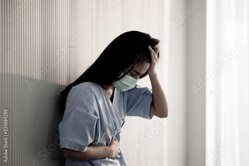 Asian patient woman wearing mask protect virus from sickness in hospital © wckiw