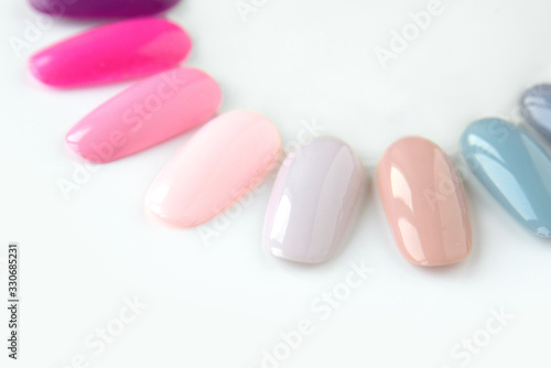Nail polish samples in different bright colors. Colorful nail lacquer manicure swatches. Top view of nail art wheel palette.