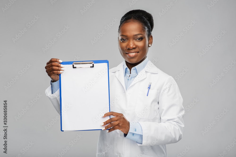 medicine, profession and healthcare concept - smiling african american female doctor or scientist in white coat with clipboard over grey background medicine, profession and healthcare concept - smiling african american female doctor or scientist in white coat with clipboard over grey background