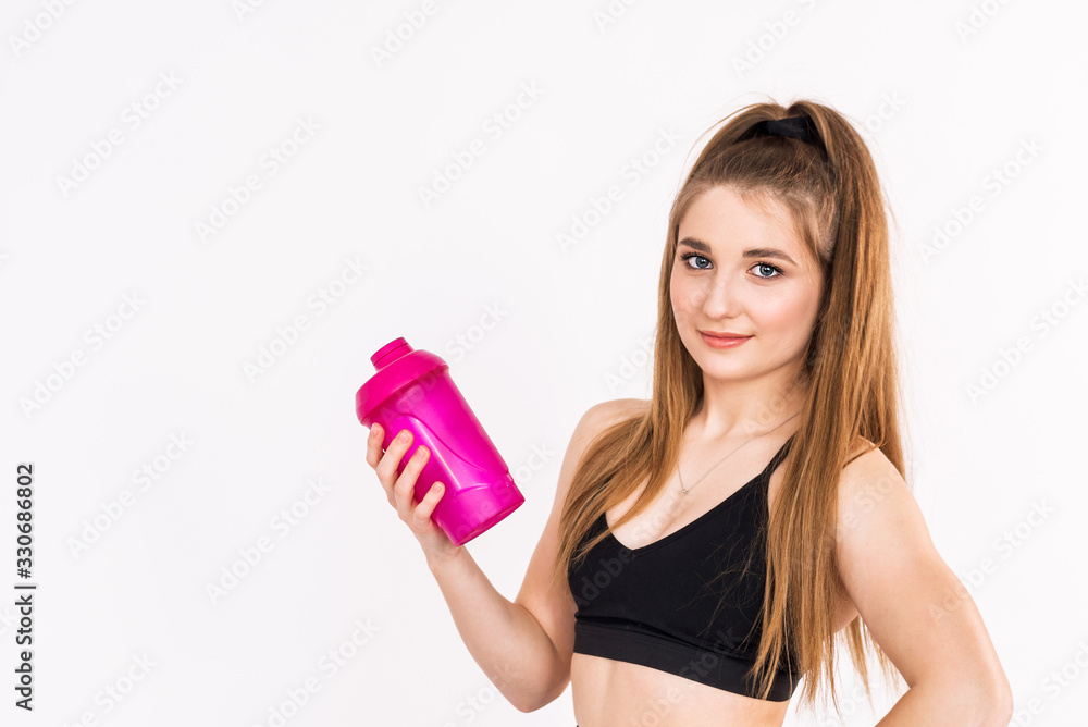 Fitness girl drinking water on a white background. Fitness girl drinking water on a white background.