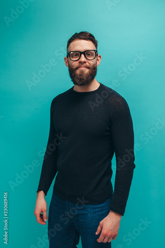 Handsome american hipster guy with beard wearing black long sleeve t-shirt or sweater with space for your brand name or label. Mockup for print