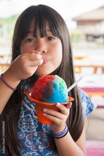 A girl holding shave ice in Hawai'i.  Being Happy