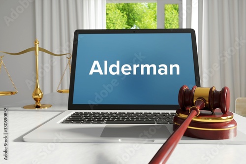 Alderman – Law, Judgment, Web. Laptop in the office with term on the screen. Hammer, Libra, Lawyer.