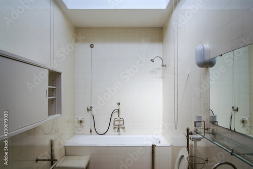 Beautiful shower bath tub in modern functionalism bathroom, white tile design wall