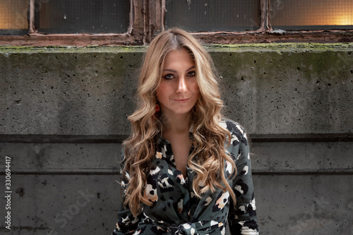 Beautiful woman with blonde long hair and blue eyes wanders the streets of Istanbul and poses for the camera