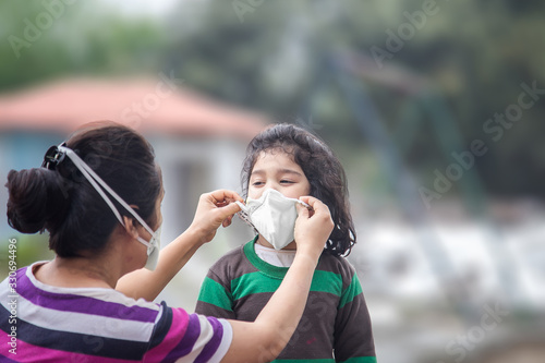 Covid-19 Coronavirus and Air pollution pm2.5 concept.Little Indian baby girl and mother wearing mask for protect and to stop corona virus outbreak 