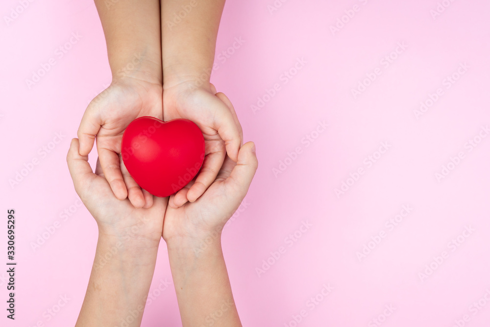world health day, adult and child hands holding red heart, healthcare, love and family insurance concept world health day, adult and child hands holding red heart, healthcare, love and family insurance concept