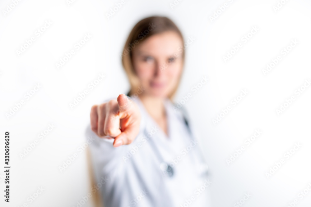 Young female doctor with pointing finger gesture Young female doctor with pointing finger gesture