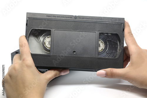 Old VHS black video cassette isolated on a white background