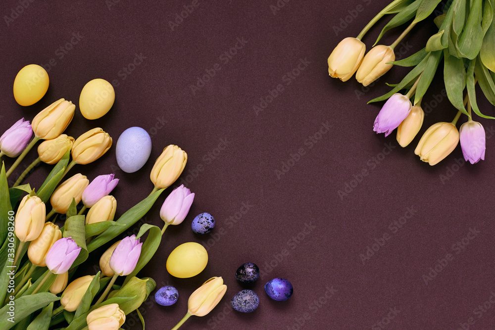 Yellow and lilac tulip flowers with easter eggs on dark background. Yellow and lilac tulip flowers with easter eggs on dark background.