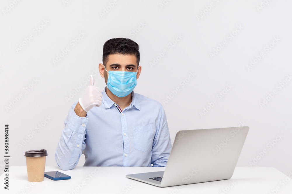 Businessman with hygienic mask and gloves, showing thumb up, recommending effective protect filter to prevent contagious disease coronavirus, 2019-nCoV, flu epidemic.  studio shot, white background