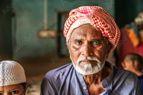 Принти на полотні a depressed homeless refugee Arab grandfather wearing traditional turbine and fe