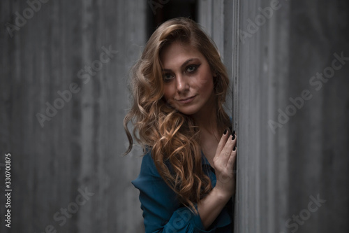 Beautiful woman with blonde long hair and blue eyes wanders the streets of Istanbul and poses for the camera