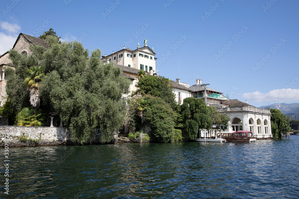 Orta San Giulio (NO), Italy - September 02, 2019: Houses view from the boat at Orta San Giulio island, Orta, Novara, Piedmont, Italy Orta San Giulio (NO), Italy - September 02, 2019: Houses view from the boat at Orta San Giulio island, Orta, Novara, Piedmont, Italy