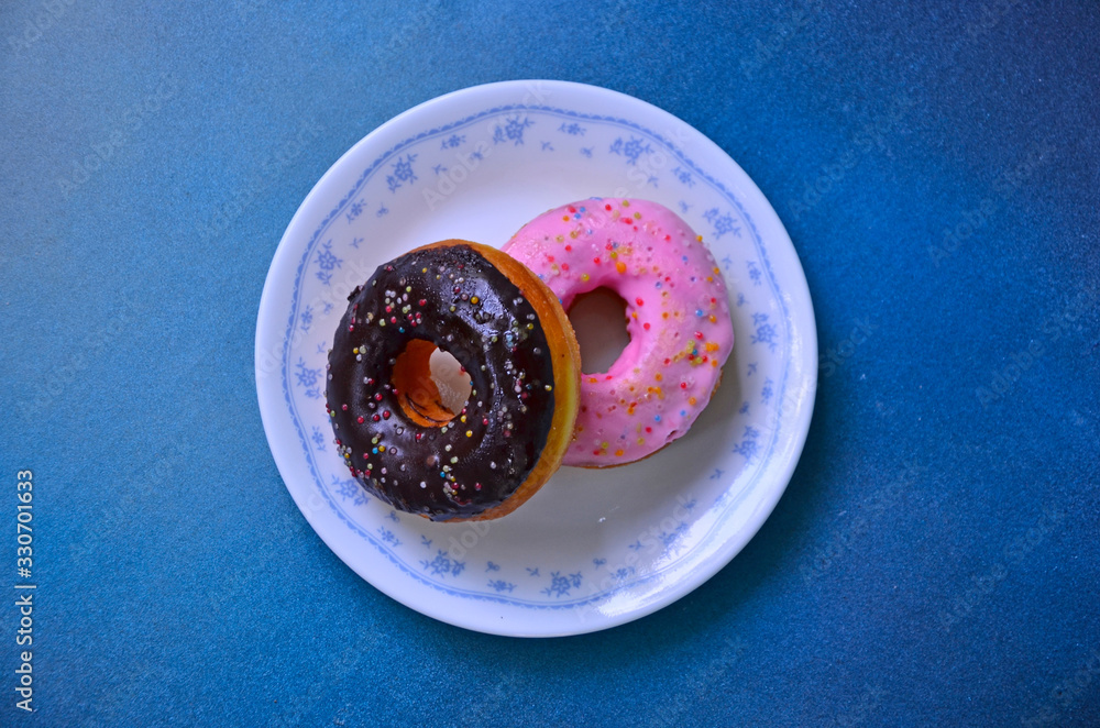 Ceramic dish of donuts with cream and sweet spots Ceramic dish of donuts with cream and sweet spots