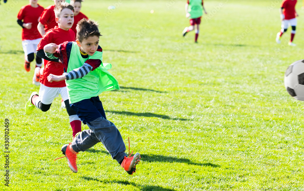 Boys play soccer sports field