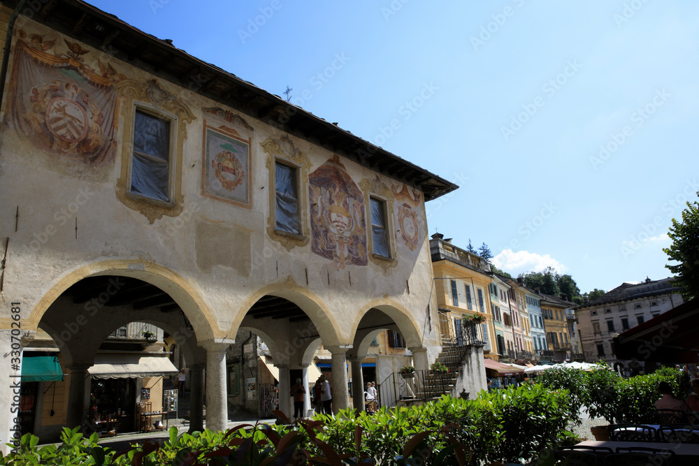 Fototapeta premium Orta San Giulio (NO), Italy - September 02, 2019: Palazzo della Comunita in Piazza Motta, Orta, Novara, Piedmont, Italy