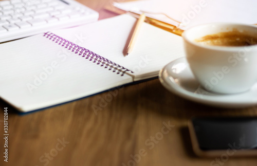 Place of work on desk. selective focus on pencil and notebook. Concept drink coffee and relax after work