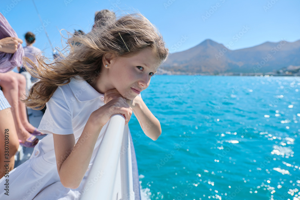 Beautiful little girl child blond with group of tourists enjoying sea voyage
