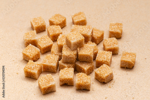 brown refined sugar cubes on craft paper background