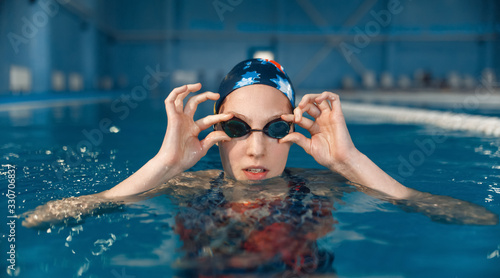 Female swimmer in pool, woman at the poolside