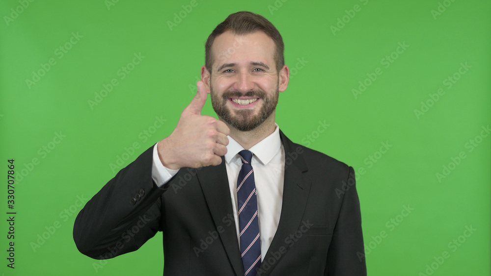 The Young Businessman Showing Thumbs Up against Chroma Key The Young Businessman Showing Thumbs Up against Chroma Key