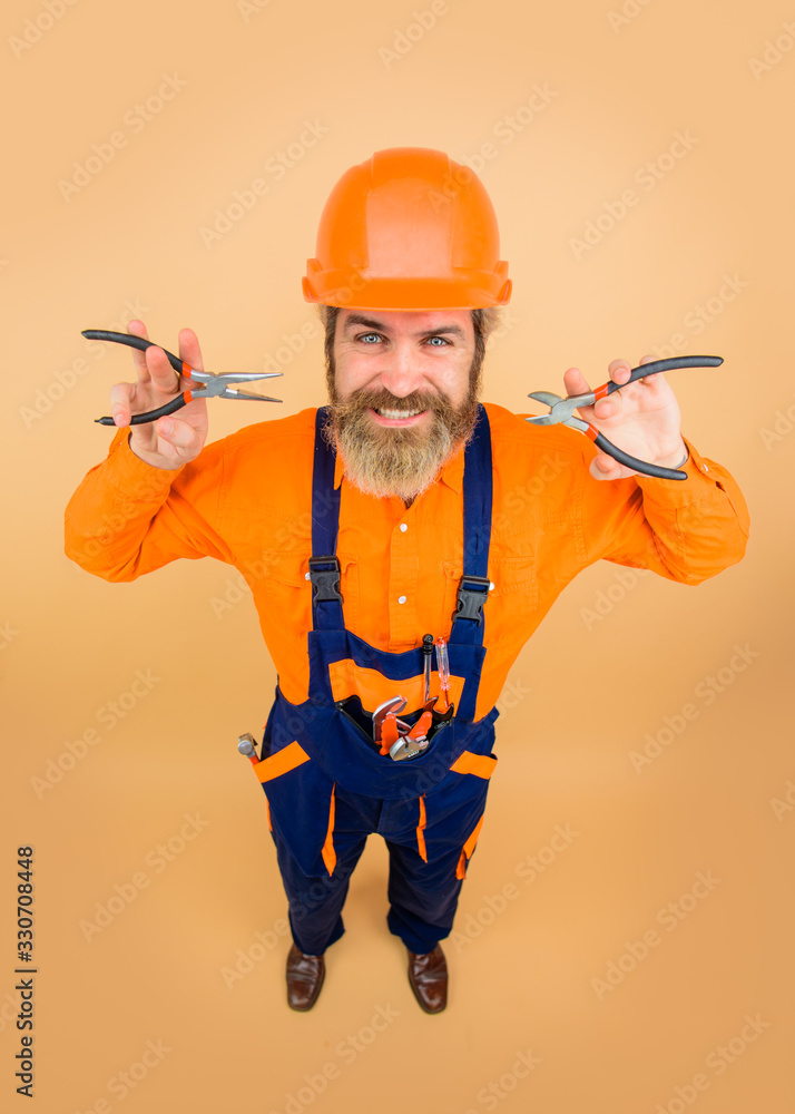 Pliers. Worker holds pliers. Repairment tools. Building. Builder in construction helmet. Builder man. Hard hat. Industrial worker. Repair. Industry. Technology. Pliers. Worker holds pliers. Repairment tools. Building. Builder in construction helmet. Builder man. Hard hat. Industrial worker. Repair. Industry. Technology.