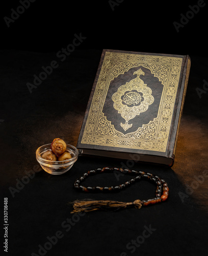 Holy Book of Quran With Rosary and Dates