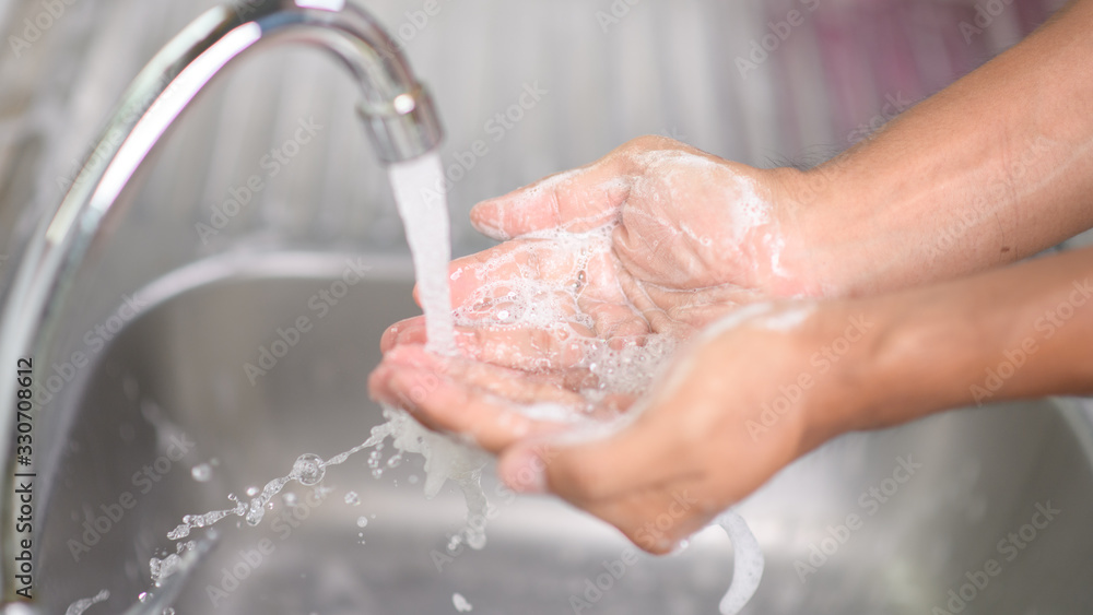 Fototapeta premium Hygiene concept. Washing hands with soap under the faucet with water